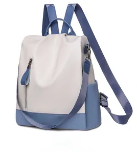 Detail view of the two-tone soft PU leather backpack showing side profile and zippers