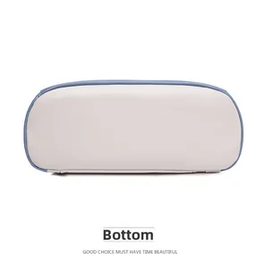 Close-up of the smooth beige PU leather bag bottom with sky blue piping details