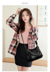 Model view of black soft PU leather crossbody bag with woven detail and multi-pockets