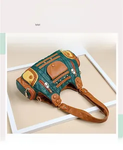Detail of color-block vintage tote bag showing pockets, rivets and woven accents