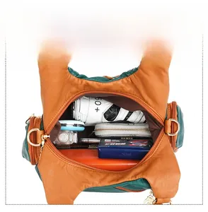 Detailed top view showing the large capacity and internal pockets of the color-block bag