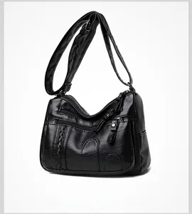 Detailed shot of black soft PU leather crossbody bag with multiple zipper pockets