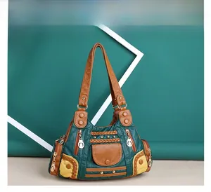 Close-up of vintage patchwork handbag featuring green brown leather and rivet details