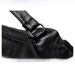 Detailed close-up of polished silver hardware and durable PU leather texture on shoulder bag