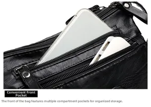 Detailed view of the multi-zipper black leather crossbody bag with organized compartments