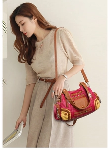 Close-up of vintage multi-color patchwork washed leather tote bag with rivet details