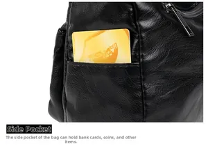 Close-up of side pocket on black pebble leather crossbody bag showing card storage detail
