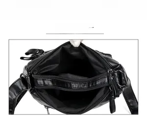 Detail view of black soft PU leather handbag with dual main compartments and inner zipper divider
