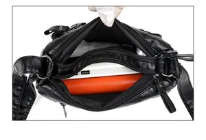 Top view of a black soft PU leather shoulder bag showing multiple zipper compartments