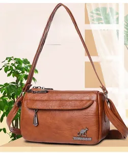 Close-up of brown PU leather texture and kangaroo logo on the trendy crossbody bag