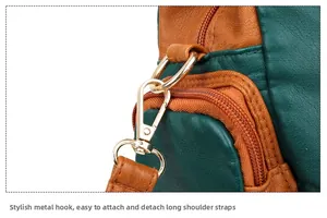 Detail of textured golden metal hook for easy long shoulder strap attachment on leather bag