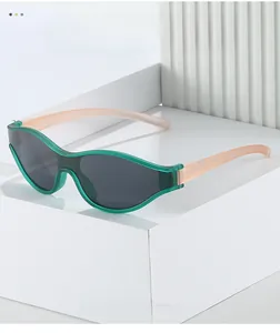 Detailed close-up of green and pink translucent cycling sunglasses with gray lenses