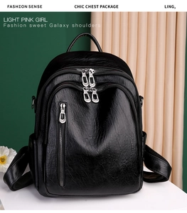 Detail of soft black PU leather backpack showing multiple metal zippers and texture