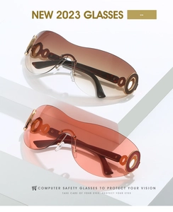 Detail of Y2K shield sunglasses showing golden hollow ring hinge and gradient lenses