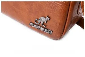 Detail of brown litchi pattern leather bag with metal kangaroo logo and brand engraving