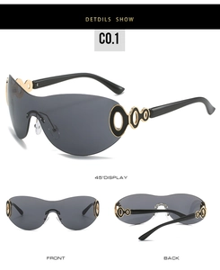 Detail of Y2K shield sunglasses showing golden hollow ring decoration on deep grey lens
