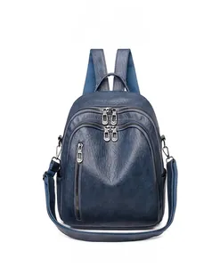 Front view of textured dark blue PU leather backpack with multiple zipper compartments