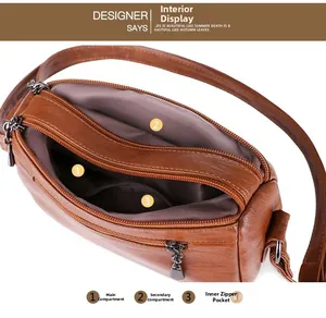 Detail view of the brown PU leather handbag showing multiple interior compartments and lining