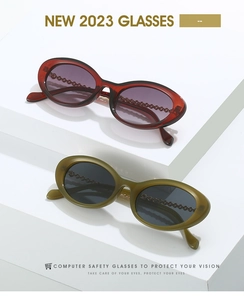 Detail of oval eyewear featuring unique chain-link texture on frames and temples
