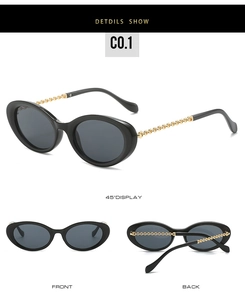 Detail view of oval sunglasses with luxury gold chain temples and black polished frames