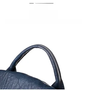 Detail view of durable blue pebbled leather handle with high quality stitching on backpack