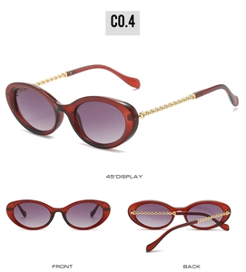 Detail view of oval dark red sunglasses with gold chain-link arms and purple gradient lenses