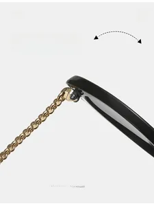 Detail of durable metal hinge and golden chain temple on stylish black sunglasses