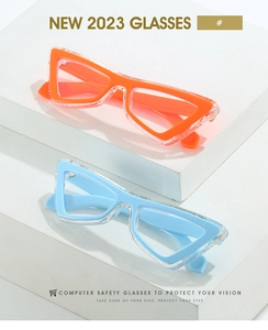 Detail of cat-eye anti-blue light glasses with glitter resin frames in orange and blue