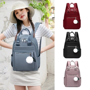 Sac à dos chic en tissu Oxford pour femme avec breloque boule en peluche pour voyage