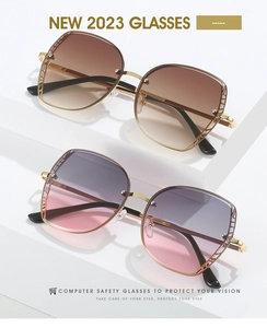 Detail view of gold metal frames with hollow geometric mesh and gradient color lenses