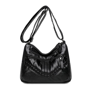 Soft black PU leather crossbody bag with multiple zippers and woven V-shaped detail