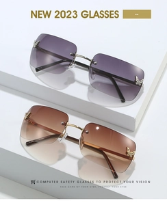 Close-up of rimless butterfly sunglasses with sparkling crystals and metal accents