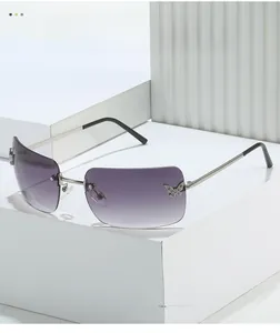 Detail of purple gradient rimless sunglasses with metal butterfly accents on the lenses