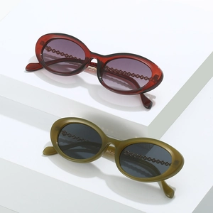 Vintage small oval sunglasses with translucent frames and unique metal chain temple design