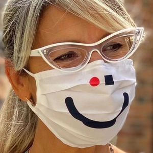 Woman wearing white cat-eye TR glasses and patterned mask in soft natural outdoor light