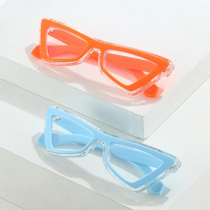 Cat eye blue light blocking glasses in bright orange and sky blue on white stone base