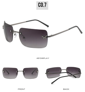 Detail view of rimless sunglasses with gradient lenses and rhinestone butterfly accents