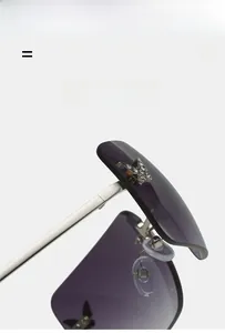 Detail of Y2K rimless sunglasses with purple gradient lenses and diamond butterfly accents