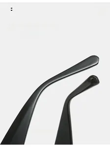Detail of high-gloss ergonomic curved black temples on minimalist diamond sunglasses