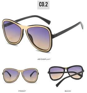 Black and gold oversized aviator sunglasses with gradient purple to orange lenses