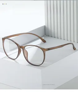 Detail view of transparent brown TR90 large round glasses frames on geometric display