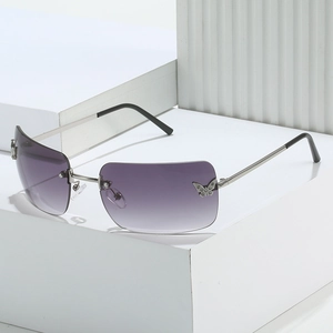 Frameless Y2K sunglasses with purple gradient lenses and sparkling butterfly rhinestones