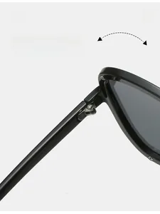 Macro shot of durable metal hinges and size specs on black oversized pilot sunglasses
