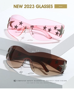 Close-up of frameless sunglasses with black star patterns and silver metal star hinge