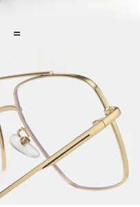 Detail of gold metal pilot frame with transparent lenses and soft silicone nose pads