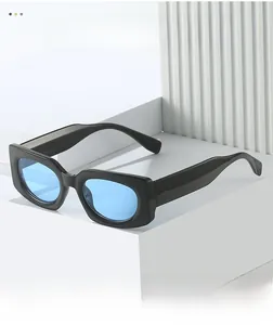 Detail of square black frame sunglasses with light blue lenses on geometric stand