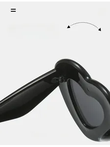 Detail of durable texture hinge on Y2K heart shaped sunglasses in glossy black finish