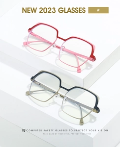 Detailed view of geometric metal eyeglass frames in pink and black color blocking