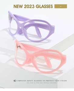 Detail of pink and purple Y2K wrap-around cat-eye glasses on a geometric display