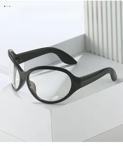 Detail of trendy Y2K oval black frame glasses with clear lenses on a minimalist stand